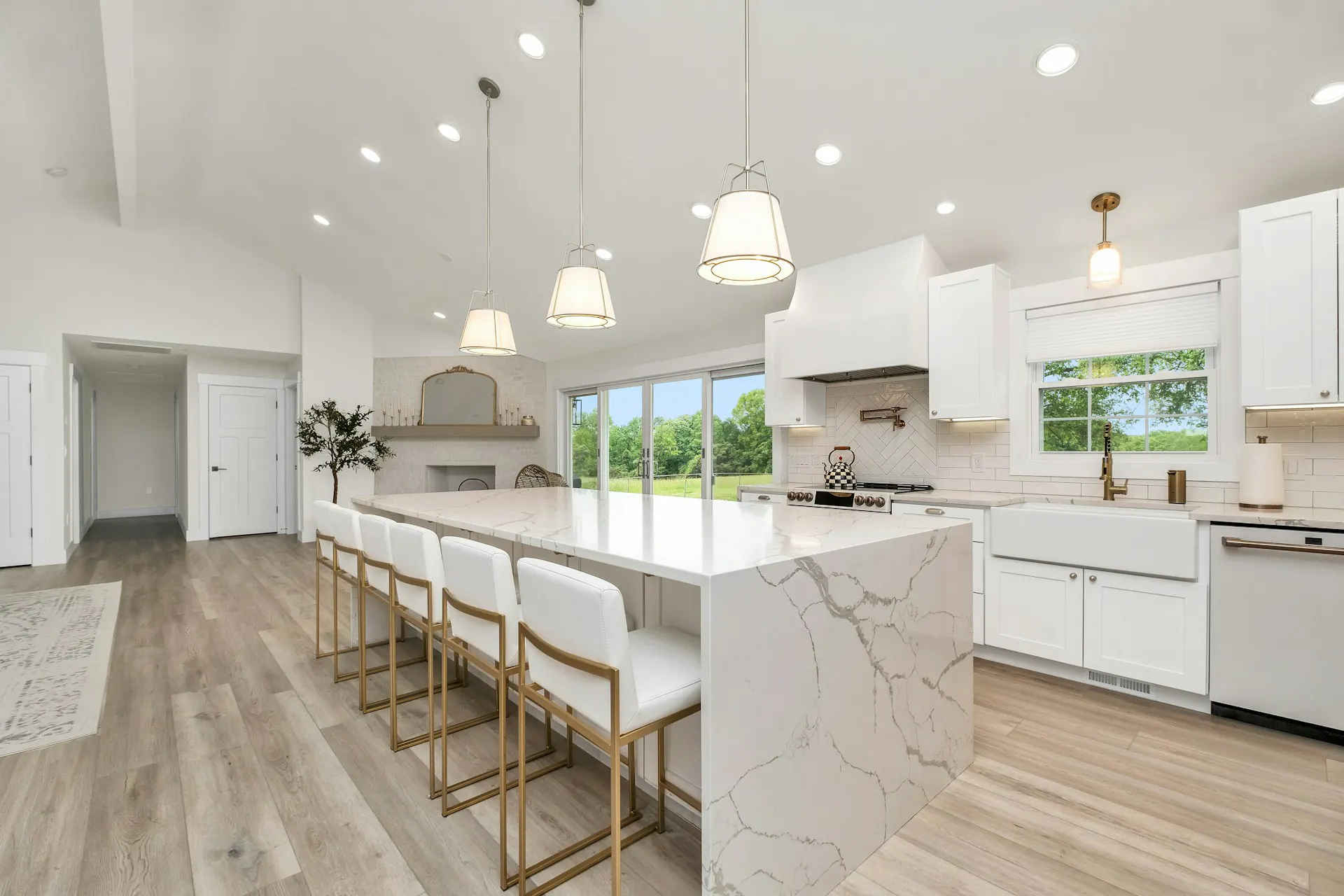 Pre-war estate kitchen in Englewood NJ — large white cabinetry, marble island, formal proportions consistent with the city housing stock